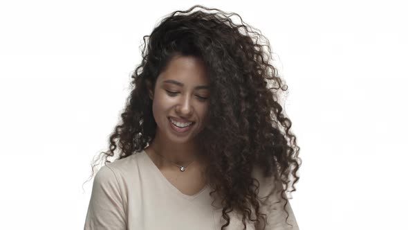 Closeup of Attractive Carefree Woman with Long Curly Hairstyle Whip Hair and Smiling Happy Enjoying alt