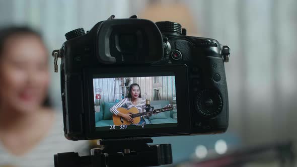 Close Up Of A Camera Monitor Recording Asian Woman Waving Hand And Speaking alt