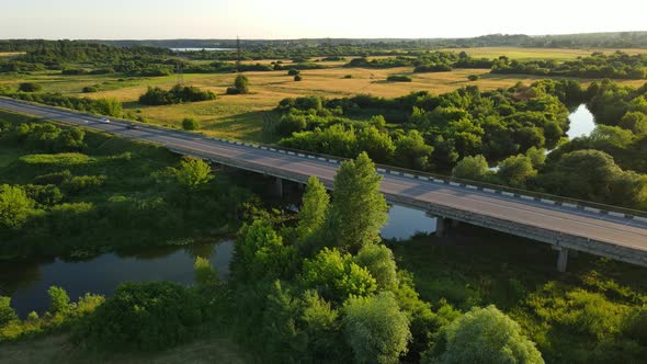 A Bridge That Cars Drive Across A Wide River