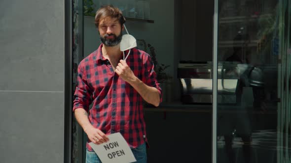 Happy Business Owner Hold Sign End of Quarantine alt