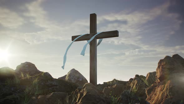 Cross on a Rocky Hill at Sunset