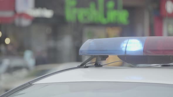 Flashing Flasher on the Roof of a Police Car. Blinker. Close-up. alt