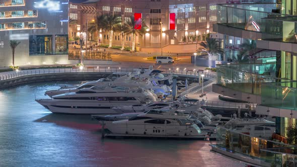 Waterfront Promenade in Dubai Marina Aerial Night Timelapse alt