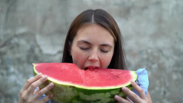 Portrait of a Beautiful Young Woman Eating Watermelon