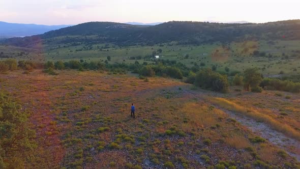 People Walking the Meadows at Morning alt