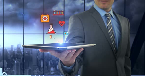 Man showing digitally generated medical icons on tablet alt
