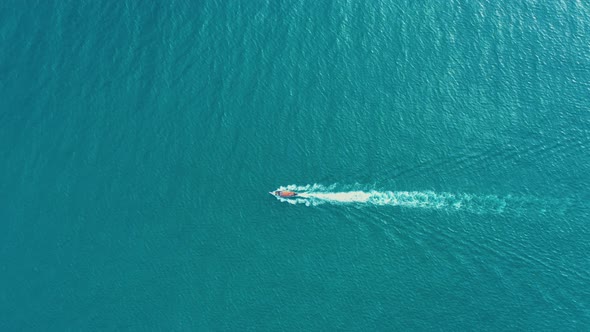 Aerial view of Long Tail Boats floating on crystal water along the sand beach in Thailand.Summer Aer alt