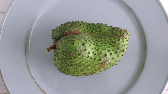 Closeup of Green Soursop Graviola, Exotic, Tropical Fruit Guanabana on Plate alt