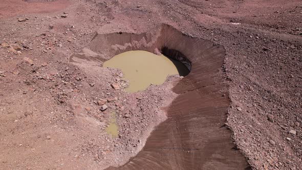 A Moraine Lake Among a Glacier Covered with Rocks alt