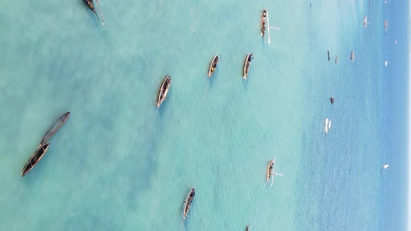 Vertical Video Boats in the Ocean Near the Coast of Zanzibar Tanzania Aerial View alt