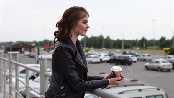 Girl Looking at the City During the Coffee Break alt