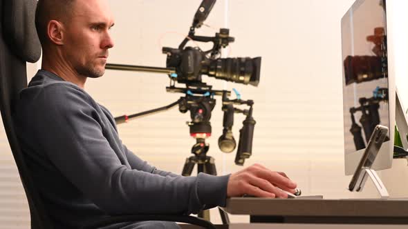 Caucasian Men Working in Front of Computer Inside Video Production Studio alt