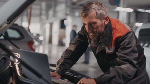 Auto Mechanic Searching for Malfunction alt