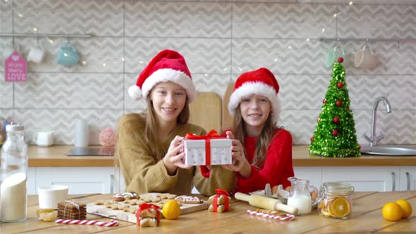 Little Girls Making Christmas Gingerbread House in Kitchen alt