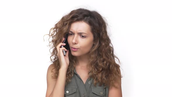 Young Curly Woman Surprising with Negative Answer Over Mobile Phone Expressing Irritation alt
