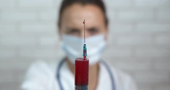 Medical worker using syringe. alt