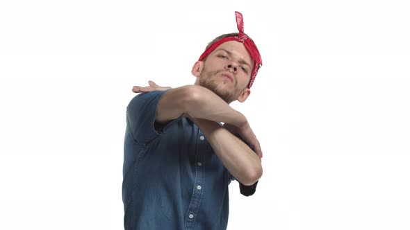 Attractive Caucasian Hipster Guy with Red Bandana Standing in Cool Pose Like a Rapper or Hiphop