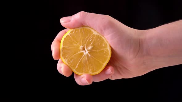 Slowmotion Lemon. The Hand Squeezes of Lemon Juice