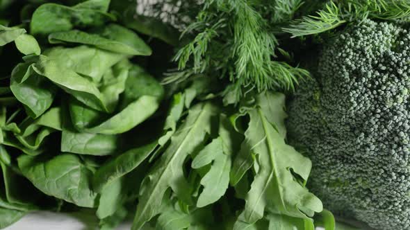 Delicious Raw Broccoli and Arugula Spinach Leaves on White alt