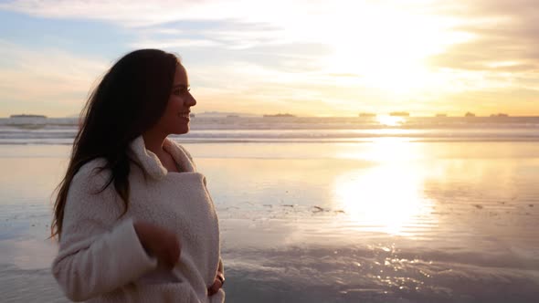 woman walking her dog on the beach alt