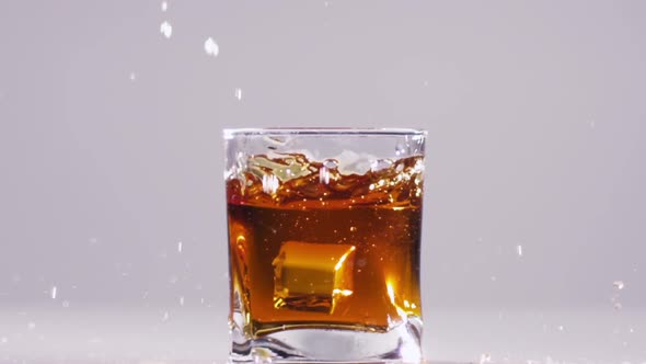 Whisky Splash Isolated on a White Background. Slow Motion. Close Up alt