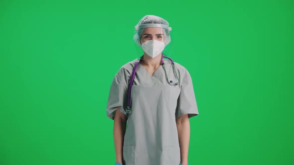 Portrait of Young Female Doctor in Protective Gear and Medical Mask Woman Looks at the Camera and alt