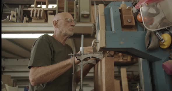 Woodworker fixing an industrial saw