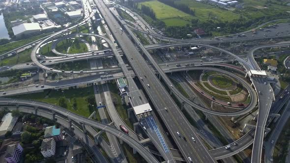 Aerial View of Highway Road Interchange with Busy Urban Traffic Speeding on Road alt