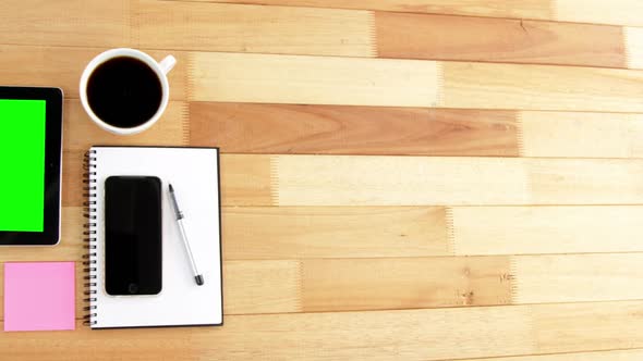 Digital tablet, coffee, spectacles, diary, mobile phone, pen and sticky notes alt