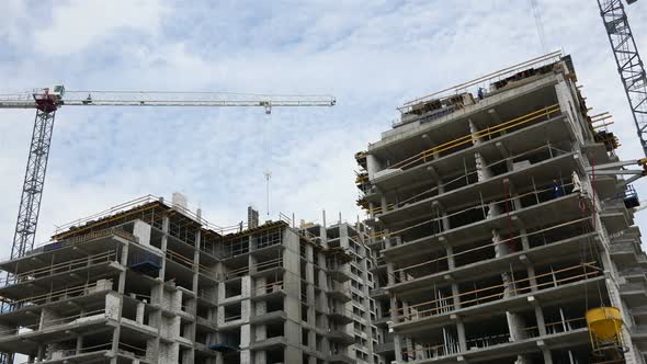 Construction Of Multi Storey Houses. Construction Crane Turns Against The Sky