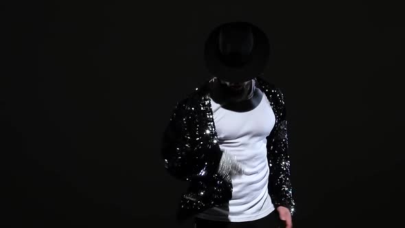 Young Stylish Man Dancing in Style Michael Jackson, Spotlight on a Black Background. Close Up alt