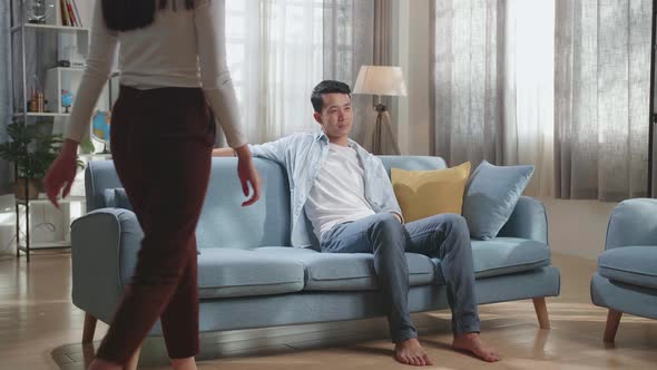 Young Asian Couple Relaxing And Watching Tv At Home alt