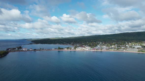 Drone fly over of a boat harbor on a partly cloud summer day alt