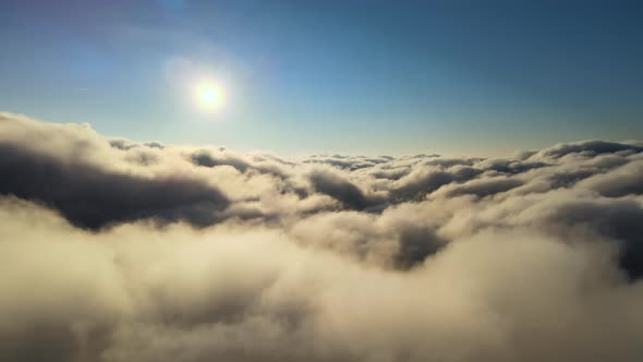 Aerial View From Airplane Window at High Altitude of Dense Puffy Cumulus Clouds Forming Before alt
