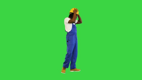 Young Handsome African American Worker Man Wearing Blue Uniform and Security Helmet Changing Poses alt