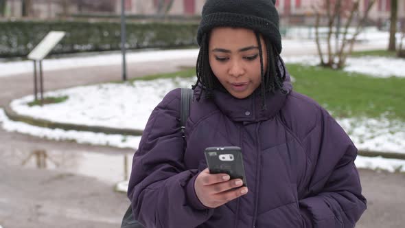 slow motion young beautiful woman using smart phone looking camera smiling alt