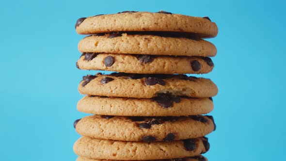 A Stack Chocolate Chip Cookies Rotate on a Blue Background alt