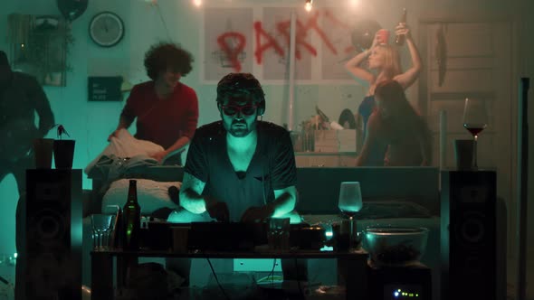 DJ Working During Party in Living Room alt