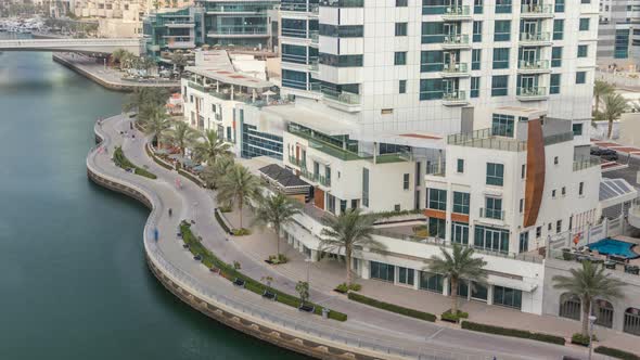 Promenade and Canal in Dubai Marina with Luxury Skyscrapers and Yachts Around Timelapse United Arab alt