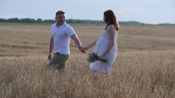 A Loving Couple Walking in the Field of Gold Rye