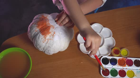 Top View on Little Girl Who Creating Craft Pumpking