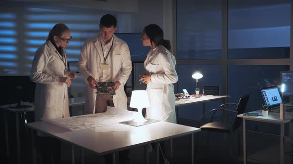 Technology Research Laboratory: Diverse Group of Engineers Discussing Electronics Development with alt