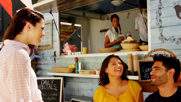 Friends interacting while having snacks alt