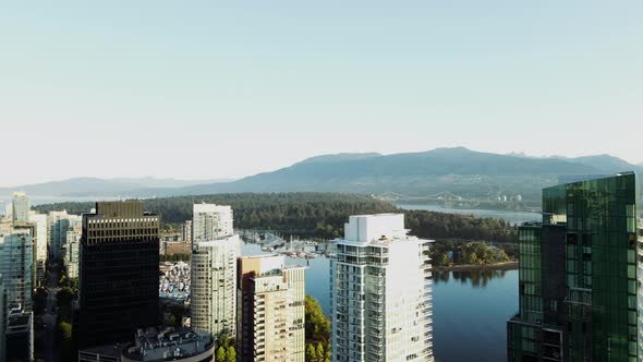 aerial drone footage of downtown Vancouver buildings and a beautiful view of Stanley Park. (British alt