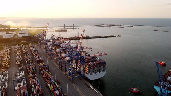 Aerial View of an Industrial Port with Cargo Ship with Containers at Sunset
