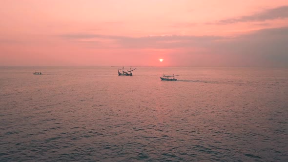 Pink Sunset Above the Sea Surface with Balinese Traditional Boats