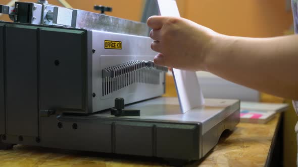 Worker Using Binding Machine in Printing Office