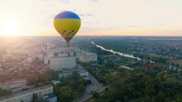 Several Hot Air Balloons Floating Over City Toward Rising Sun Over Horizon, Hope alt