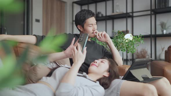 happiness home isolation concept,asian marry couple sit relax on sofa alt