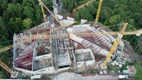 Aerial View Construction of a New Building with High Tower Cranes in Green Area alt